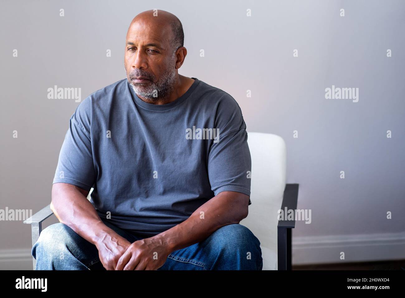 Portrait of a mature man looking sad and away from the camera. Stock Photo