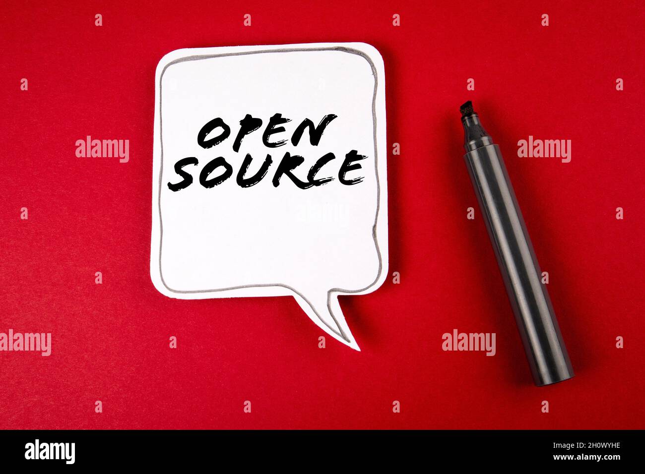 Open Source. Speech bubble and black marker on red background. Stock Photo