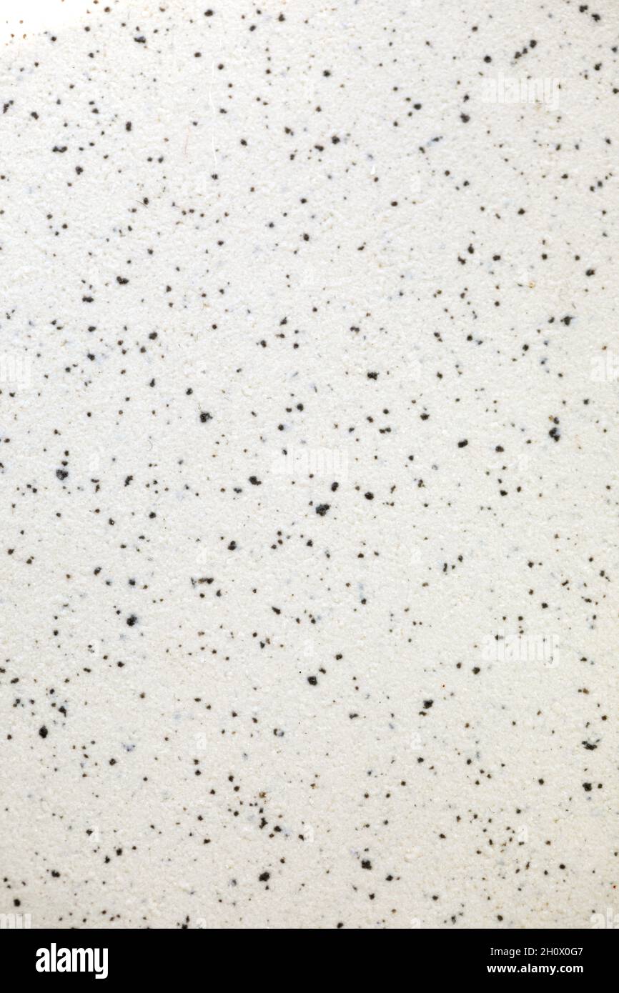 white stone marbled background with small black dots. Smooth and marble