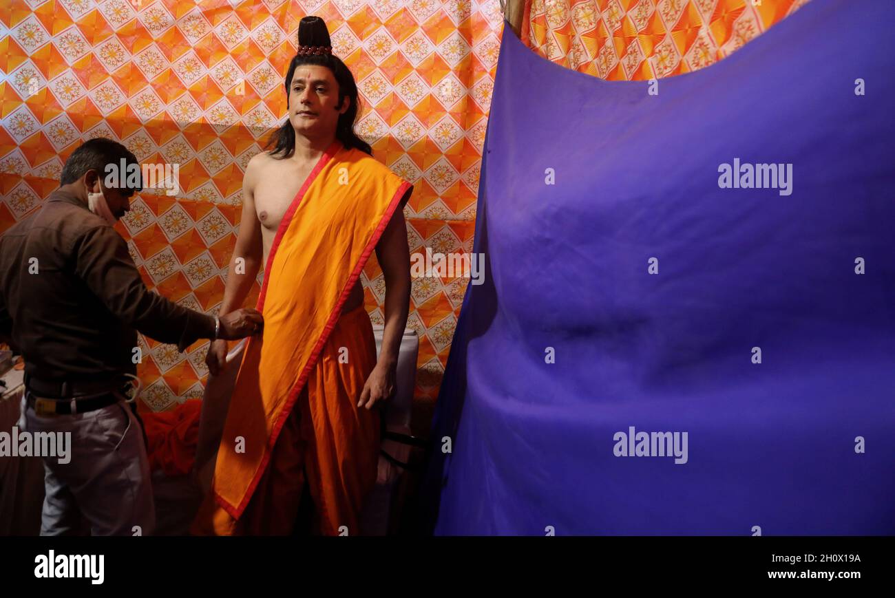 An artist backstage dressed as Lord Rama gets ready for the performance ...