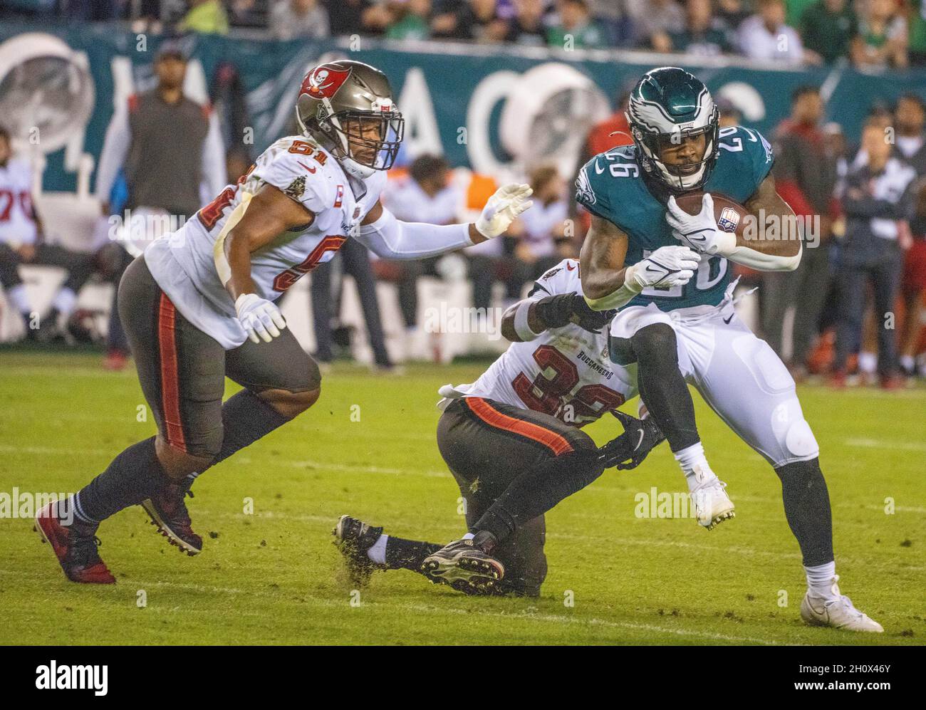 Philadelphia, Pennsylvania, USA. 14th Oct, 2021. As Tampa Bay linebacker KEVIN MINTER, #51, closes in, Eagles running back MILES SANDERS, #26, breaks free of Tampa Bay safety MIKE EDWARDS, #32, during an NFL football game between the Philadelphia Eagles and the Tampa Bay Buccaneers at Lincoln Financial Field in Philadelphia, Pennsylvania. Tampa Bay won 28-22. (Credit Image: © Jim Z. Rider/ZUMA Press Wire) Stock Photo