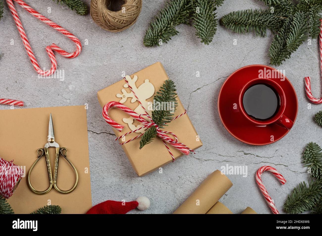 A Gift Wrapped Christmas 2022 Christmas Composition. Gift Box Wrapped In Craft Paper, Fir Tree Branches,  Candy Canes. New Year Concept. Greeting Card, Xmas Celebration 2022. Flat  Stock Photo - Alamy
