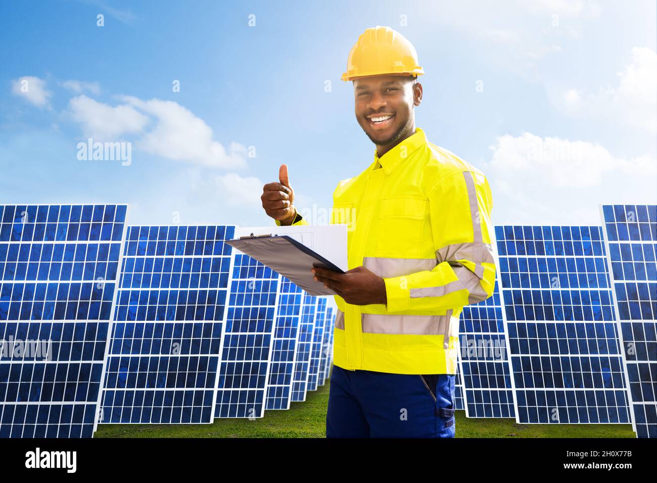 Photovoltaic Green Energy Technology. Worker At Solar Panel Plant Stock