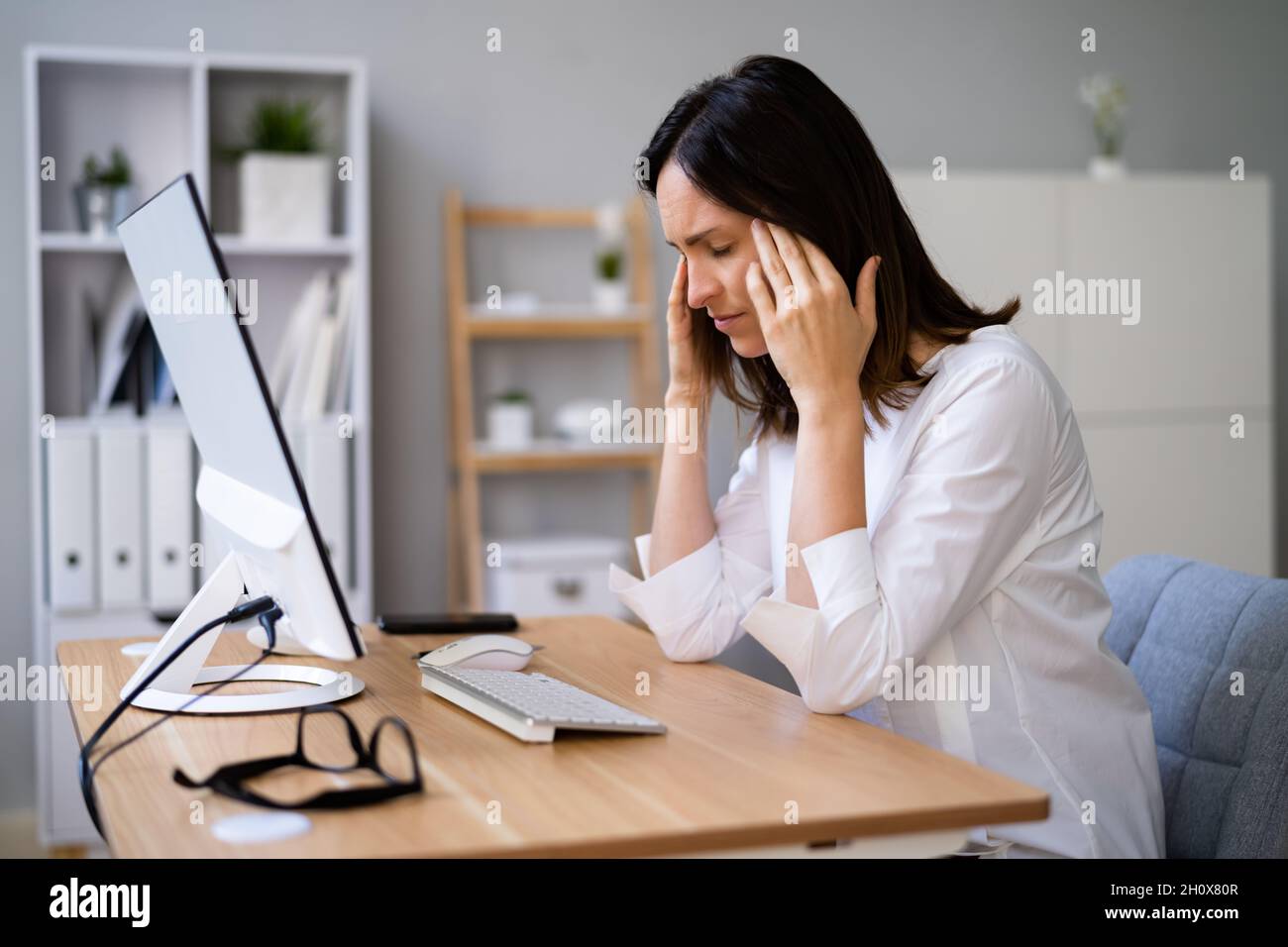 Stressful Business Woman Working On Computer In Office Stock Photo