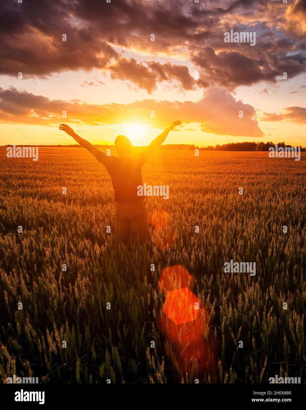 Silhouette of a man raise his hands up to sunset or sunrise on the ...
