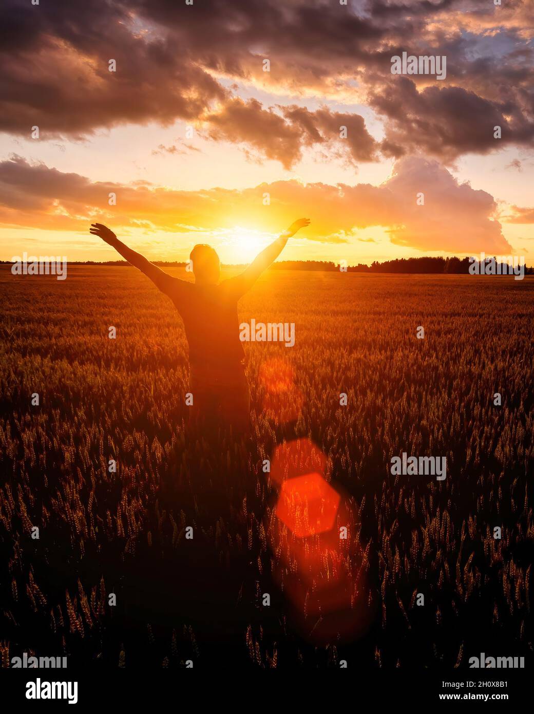 Silhouette of a man raise his hands up to sunset or sunrise on the ...