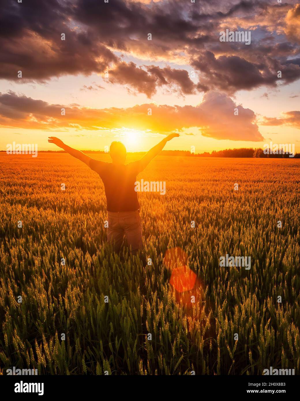 Silhouette of a man raise his hands up to sunset or sunrise on the ...