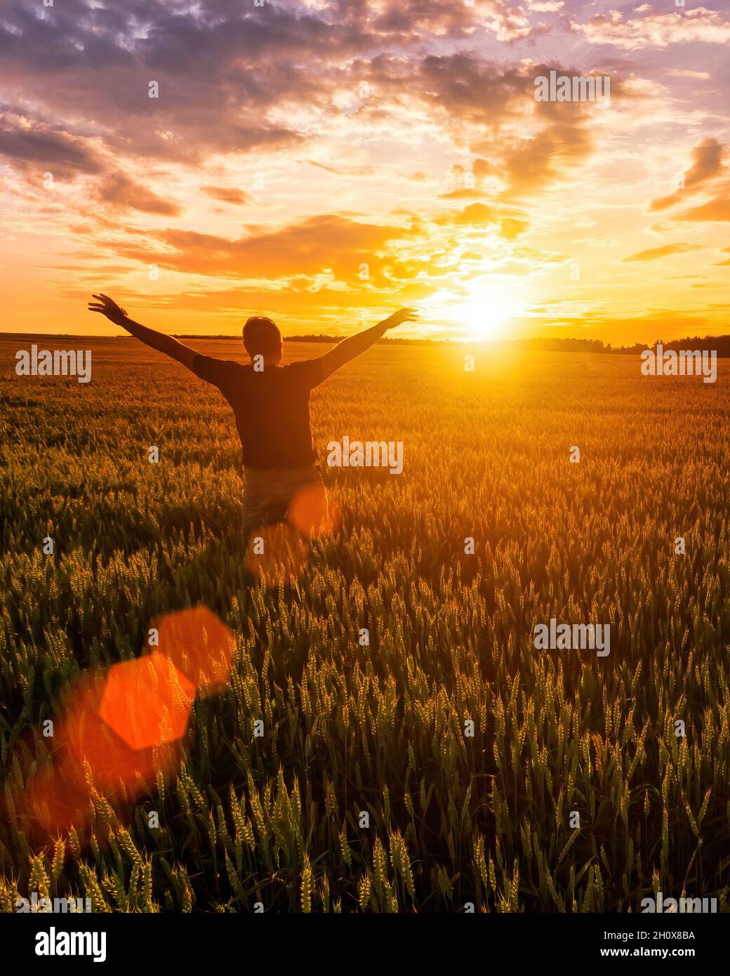 Silhouette of a man raise his hands up to sunset or sunrise on the ...