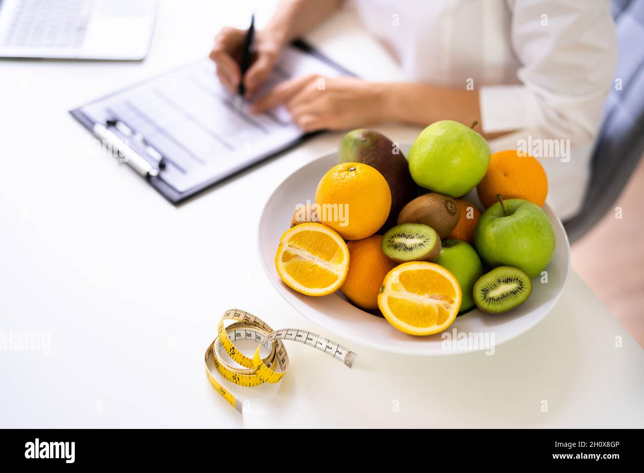 Female Nutritionist Or Dietitian In Laboratory Writing Stock Photo