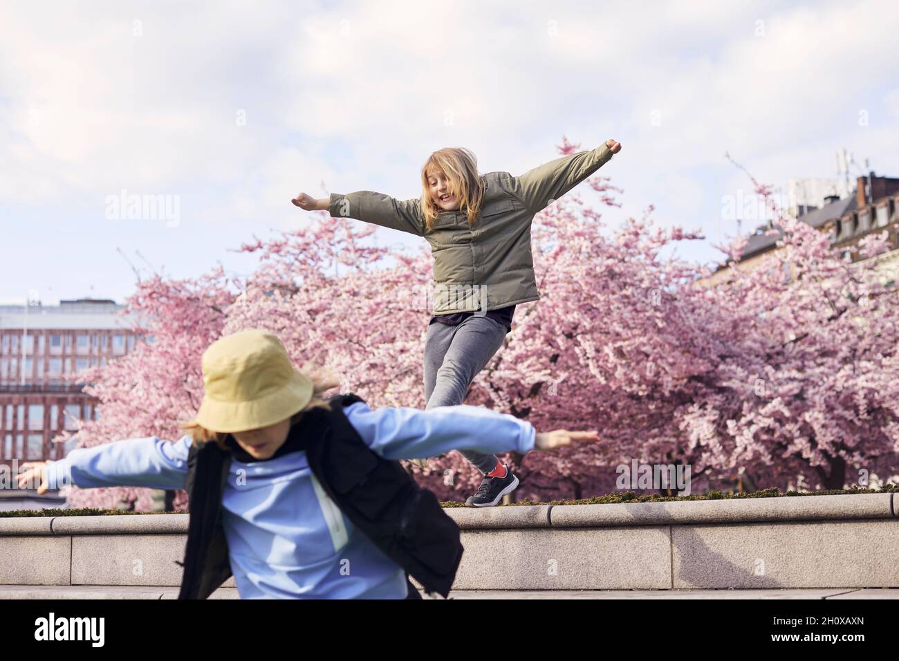 Happy girls jumping outdoors hi-res stock photography and images - Alamy