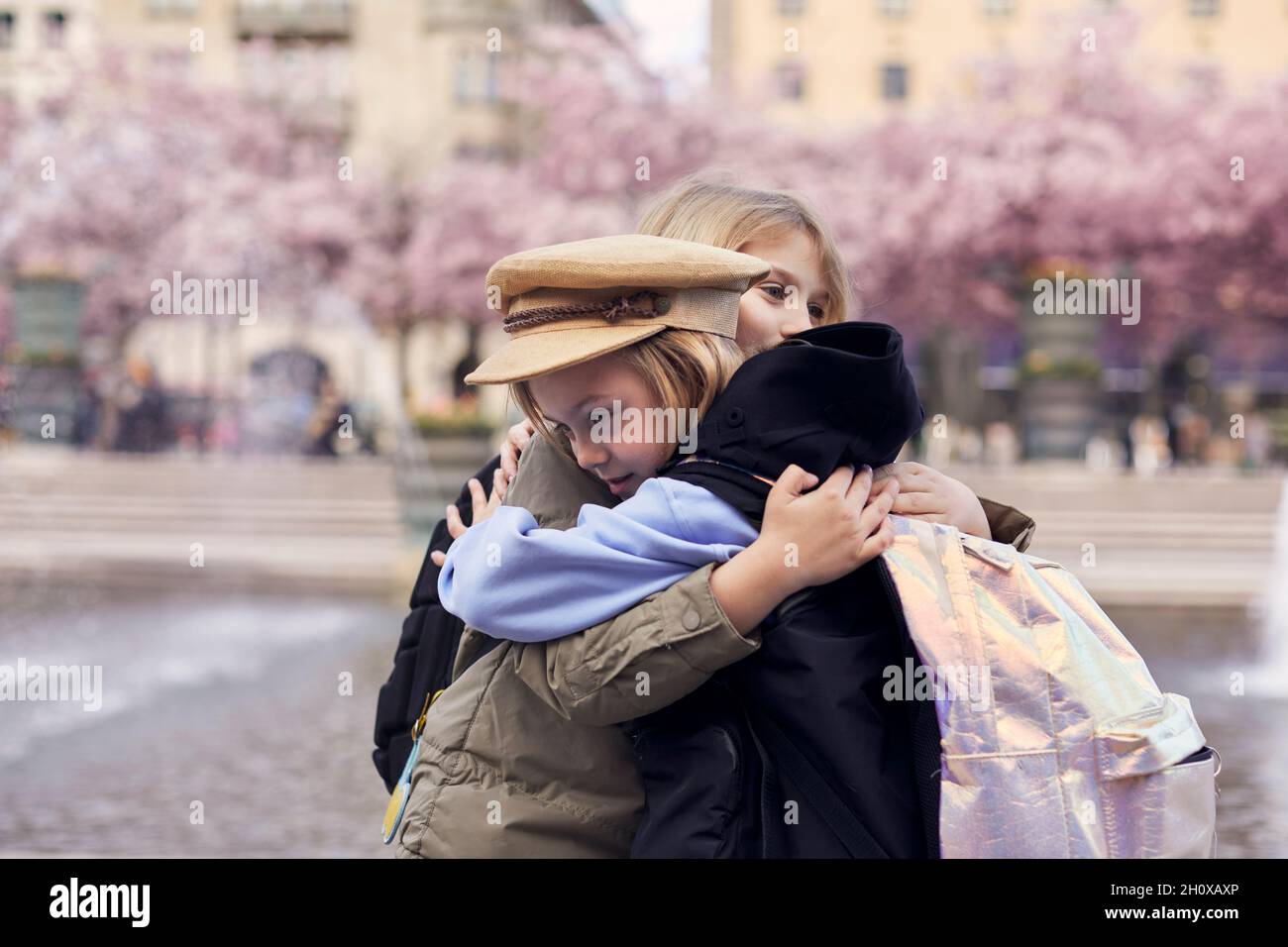 Girls hugging together Stock Photo - Alamy