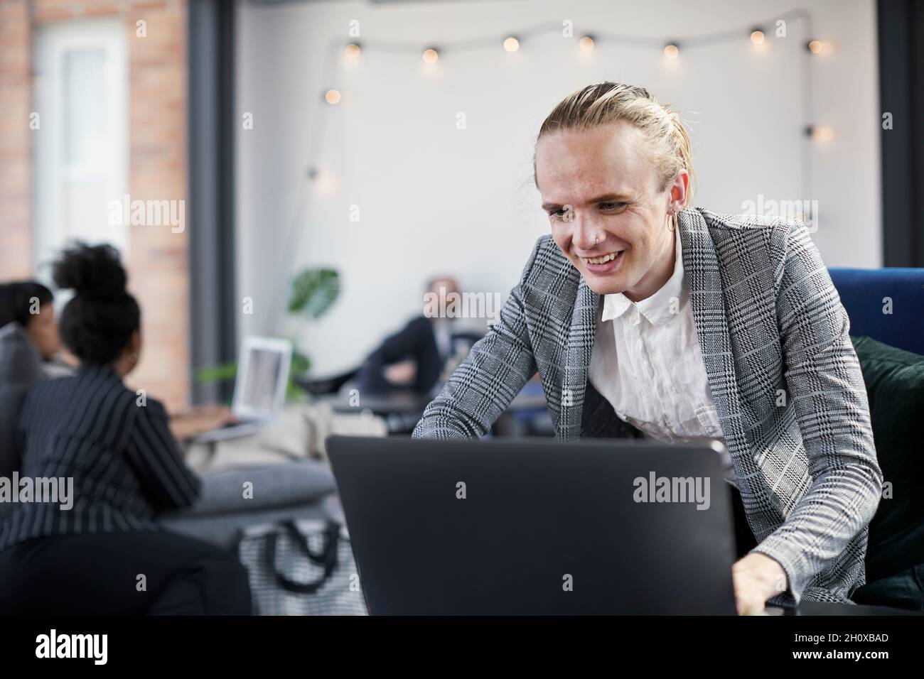 Man in modern office using laptop Stock Photo