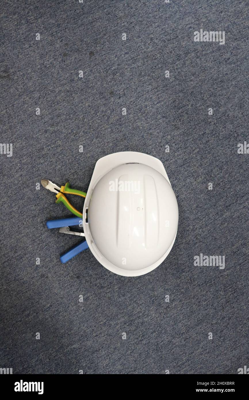 A white safety helmet to protect workers' heads from work accidents, such as collisions with hard objects, helmets are a requirement of safety first Stock Photo
