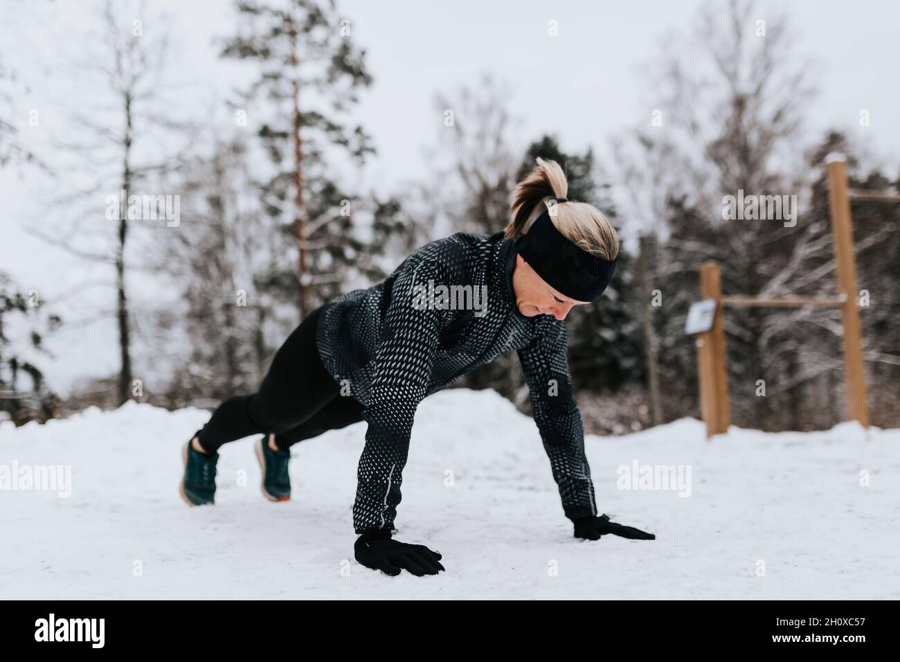 Woman doing push-ups at winter Stock Photo