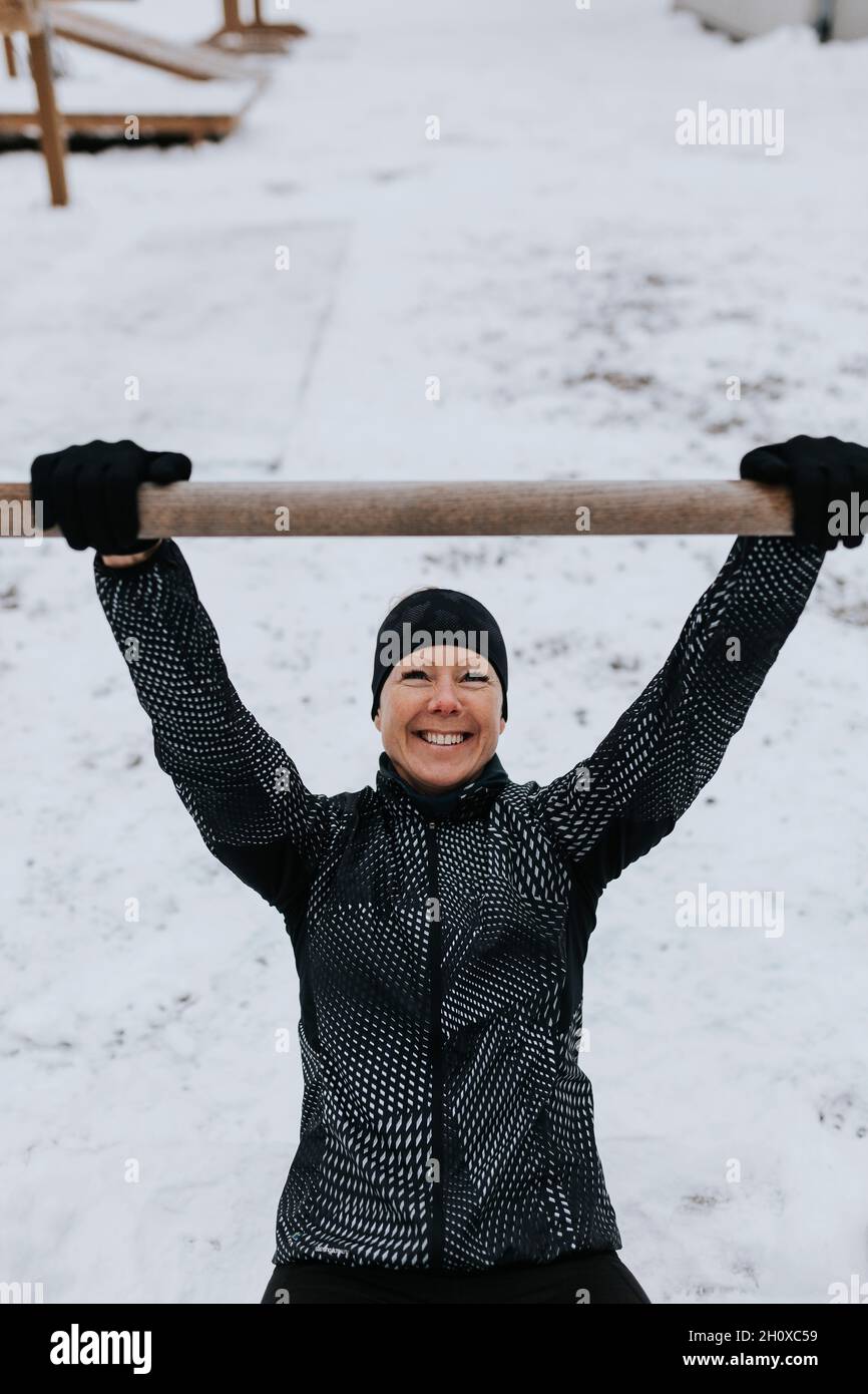 Smiling woman exercising at winter Stock Photo