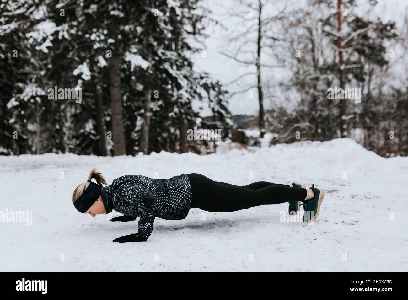 Woman doing push-ups at winter Stock Photo