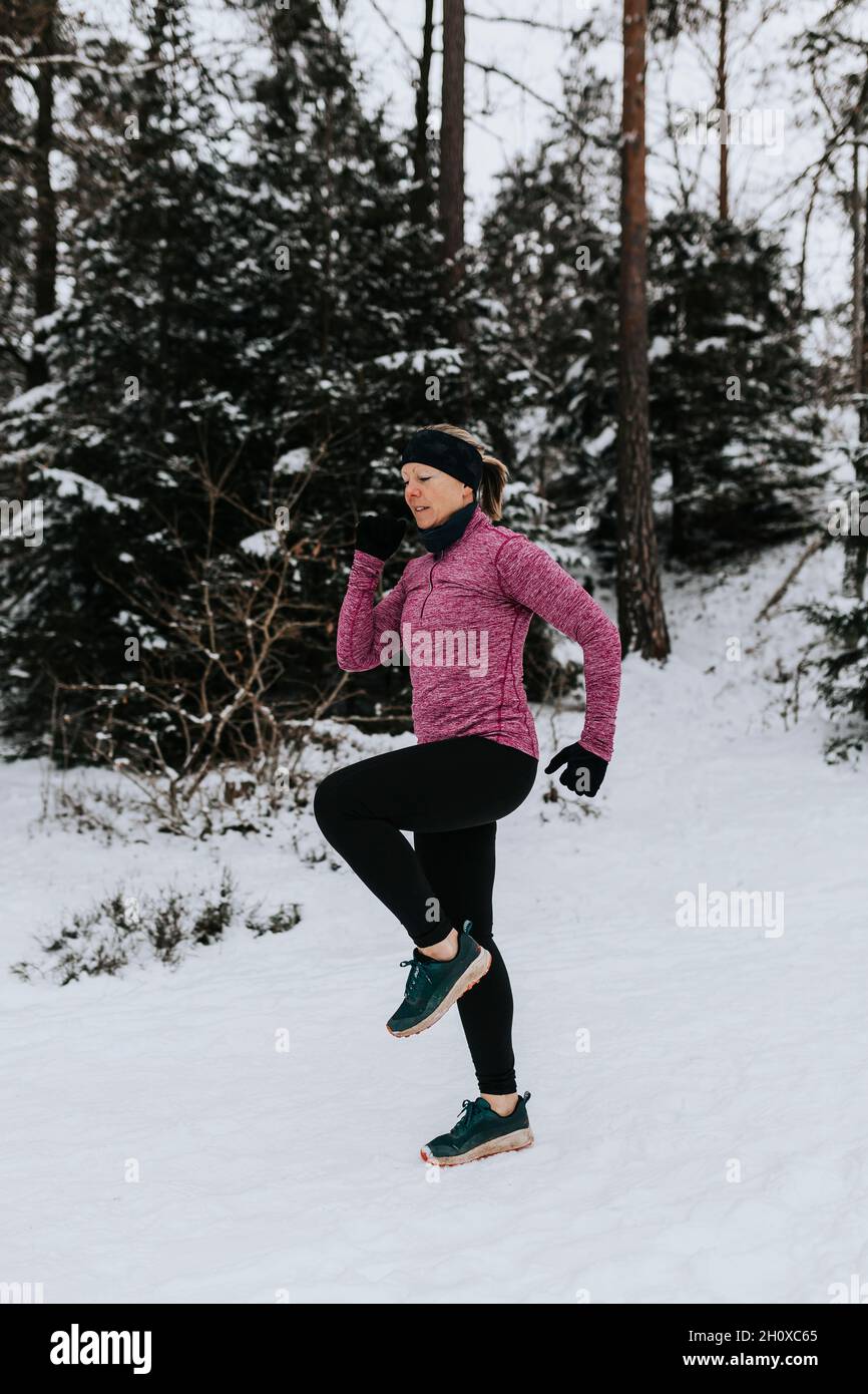 Woman exercising at winter Stock Photo