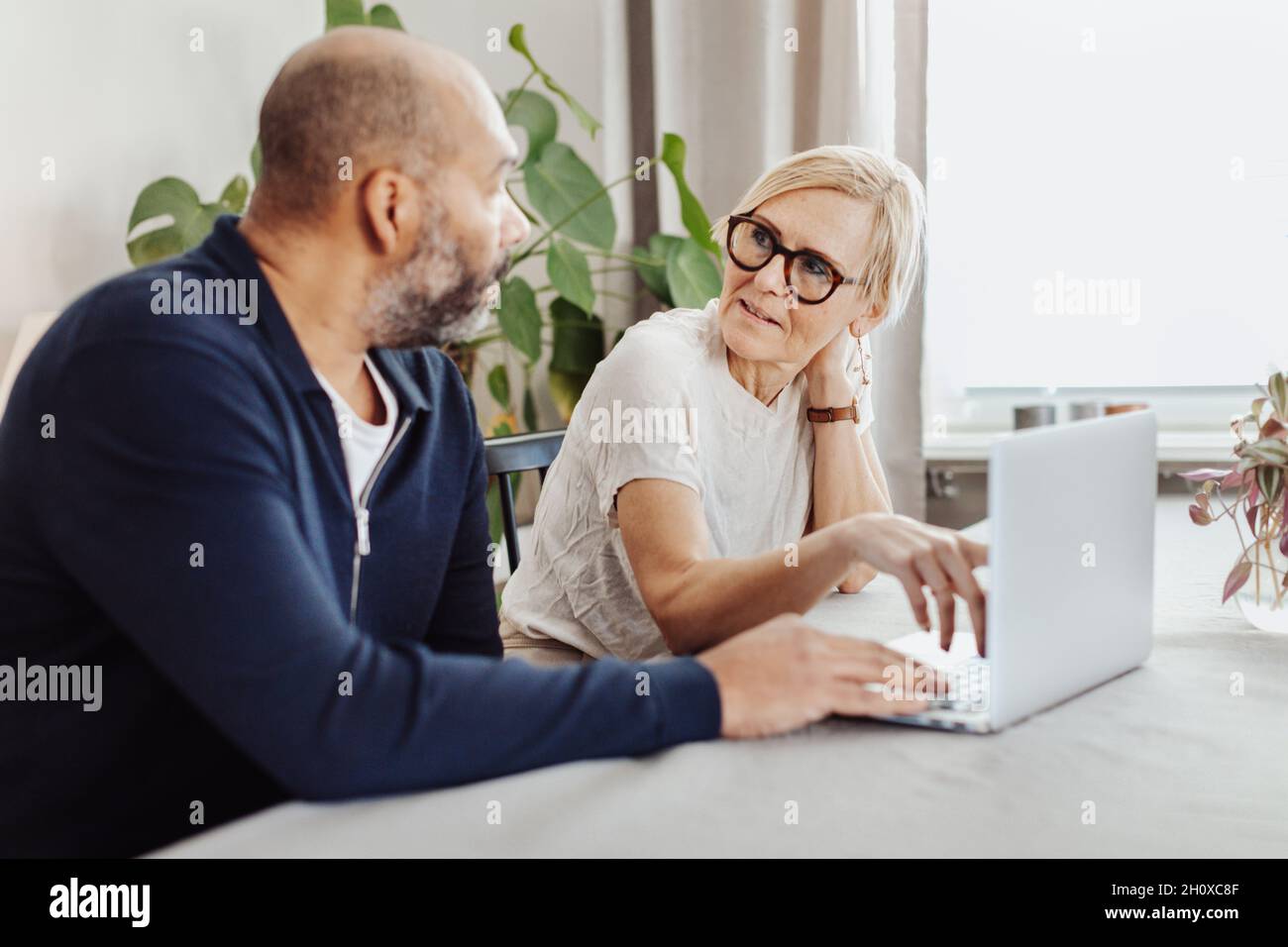 Couple using laptop at home Stock Photo