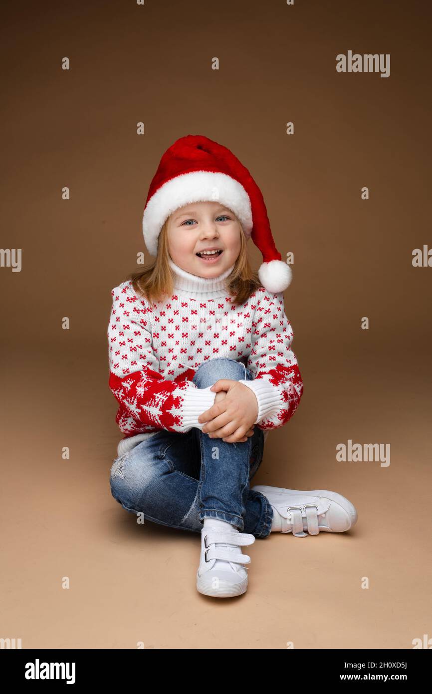 Girl sitting on the floor and hugging her knee Stock Photo - Alamy