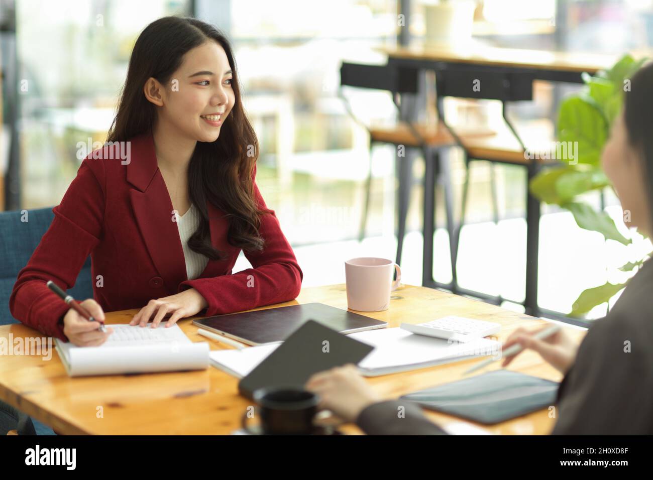 Attractive female business entrepreneur meeting with her business ...