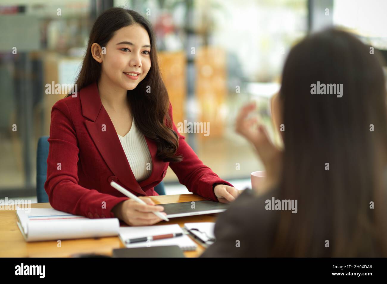 Asian business women interviewing female candidate at job interview. human resource. Business partners consulting about business benefit in office Stock Photo
