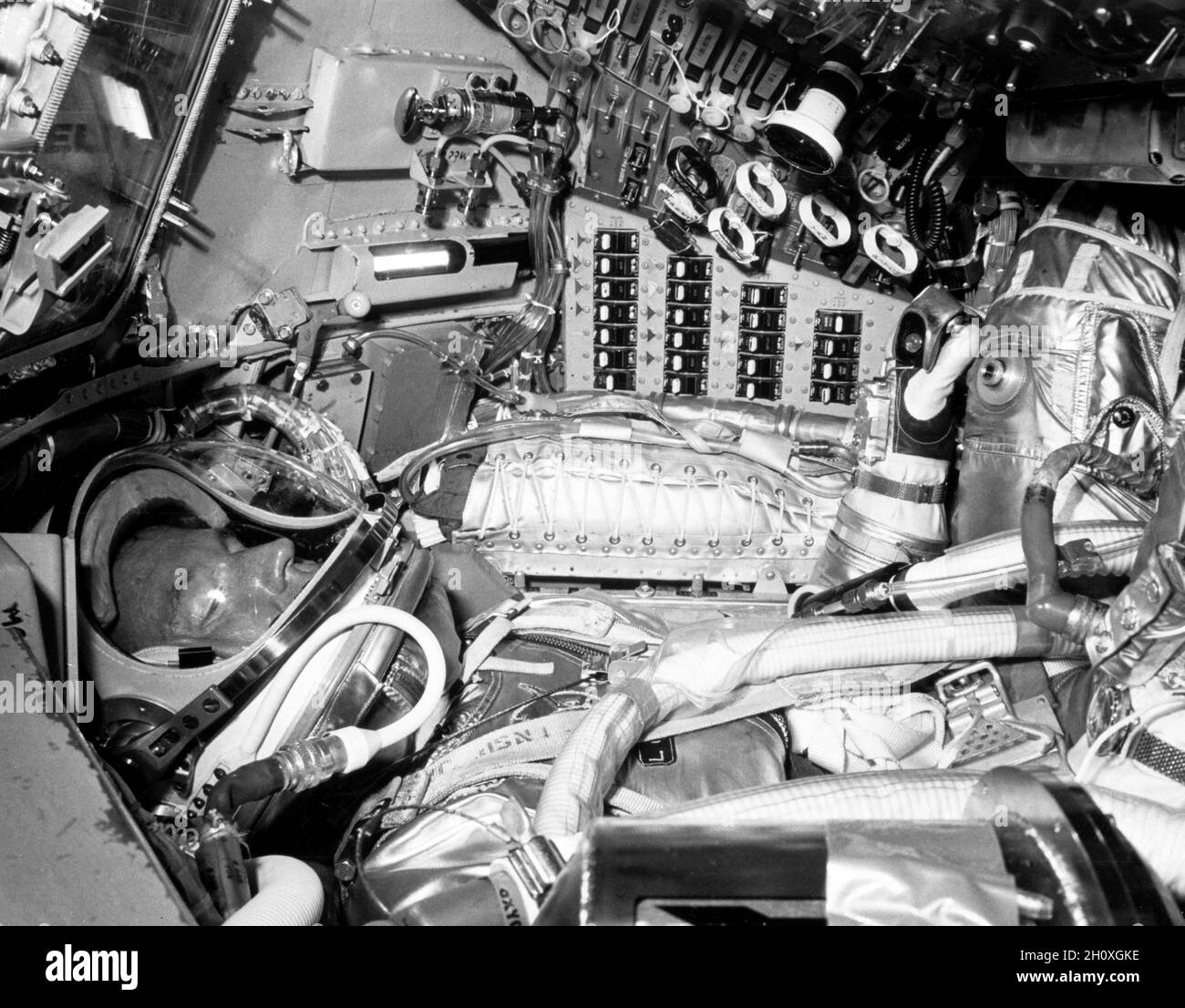 (1963) --- Astronaut L. Gordon Cooper Jr., prime pilot for the Mercury-Atlas 9 (MA-9) mission, inside his Mercury spacecraft, runs through one of the numerous preflight checks surrounded by dials, switches, indicators and buttons Stock Photo
