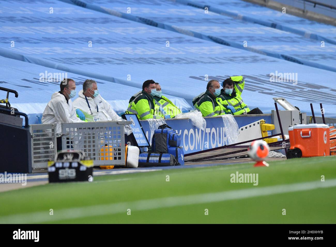 Medical staff wear face masks and gloves during the Premier League