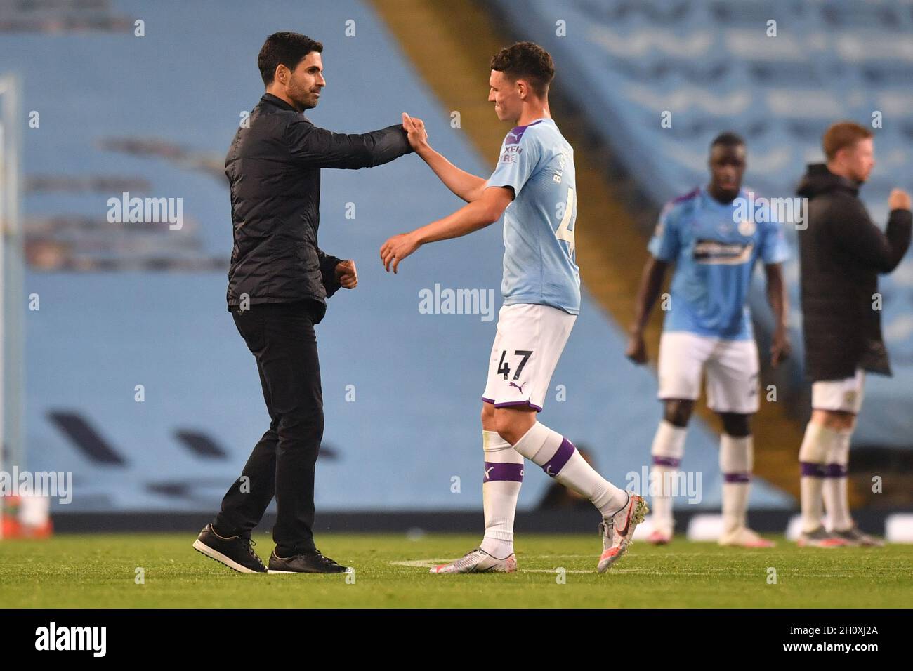 Arsenal manager Mikel Arteta and Manchester City's Phil Foden after the final whistle during the Premier League match at the Etihad Stadium, Manchester. Stock Photo