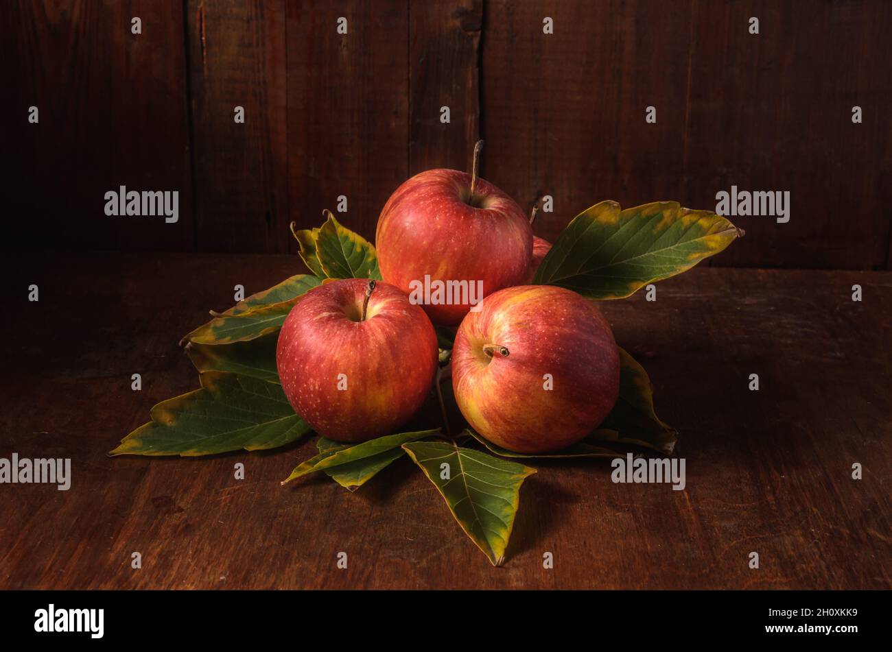 apples on a dark wooden background in a rustic style Stock Photo - Alamy