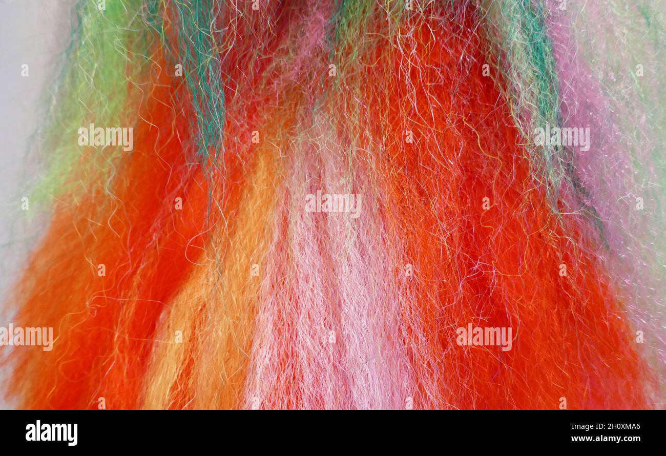 Fluffy wool-like threads in the colors red, orange, yellow, pink, white ...