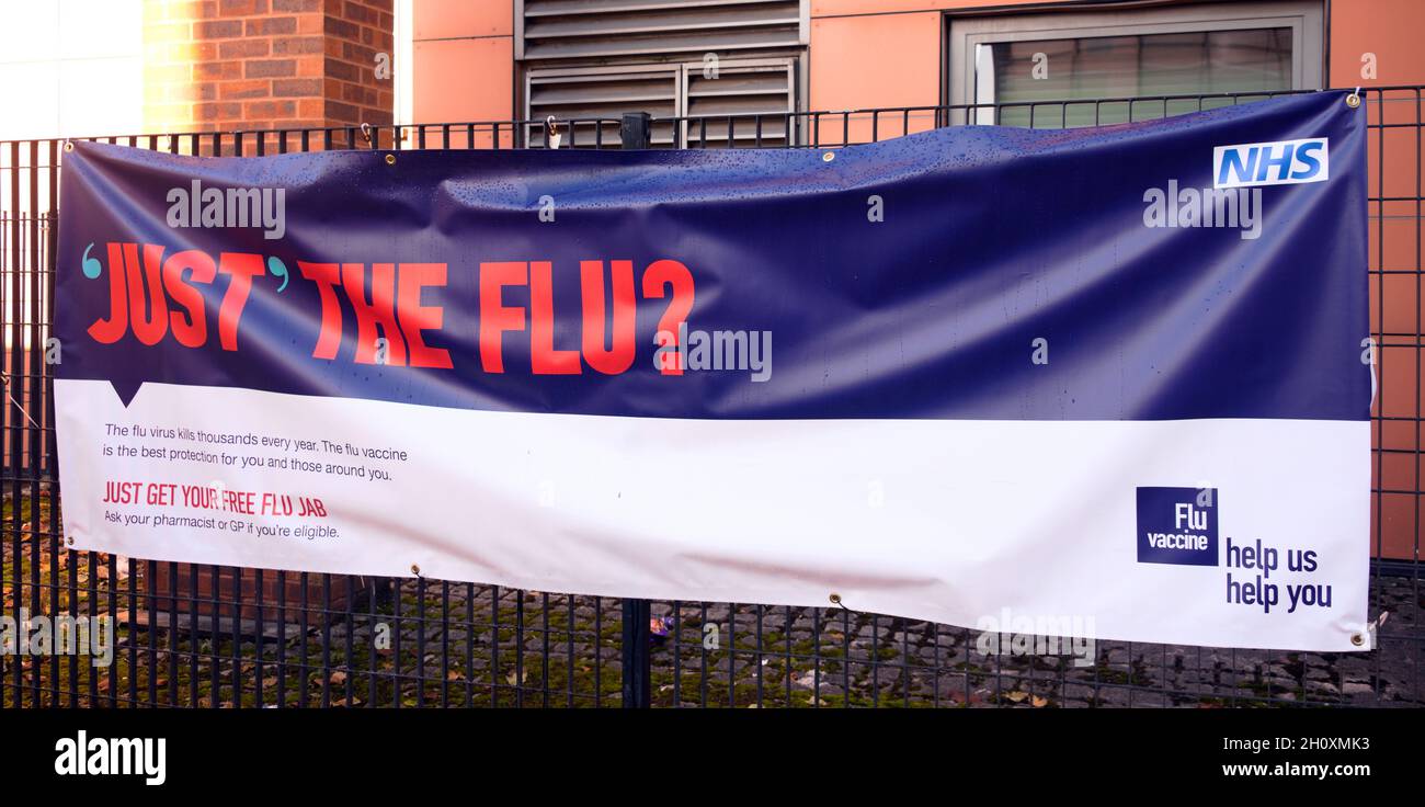 NHS banner encourages people to have the flu jab or vaccination in central Manchester, England, United Kingdom. Stock Photo