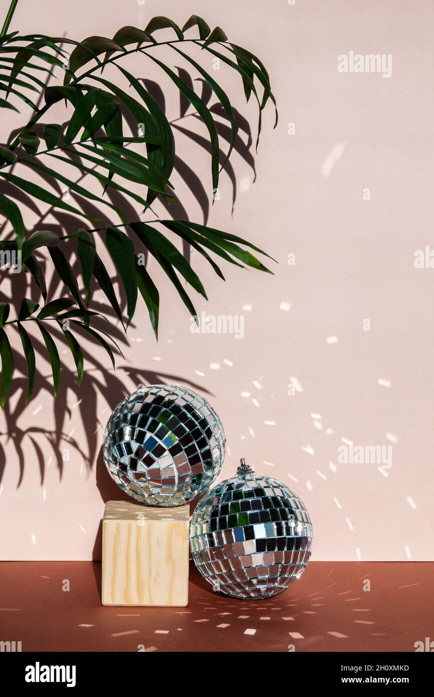 christmas decoration disco ball with sun flares on pink background