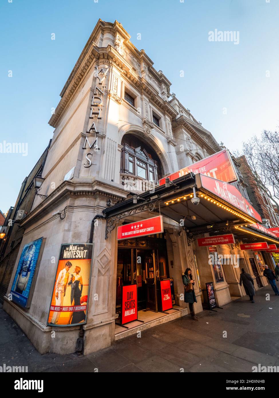 Wyndhams Theatre, London. A low, wide angle view to a theatre façade in the West End with a stage production of the film, The Man in the White Suit. Stock Photo