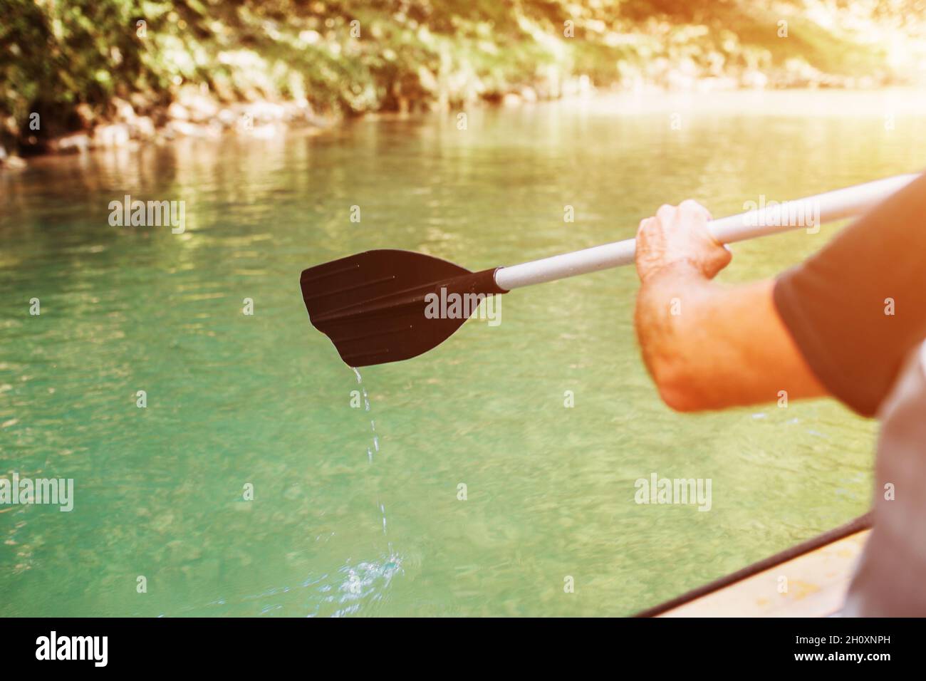 Rafting on an inflatable boat on the river in the gorge between the rocks on oars - active rest traveling in the mountains Stock Photo