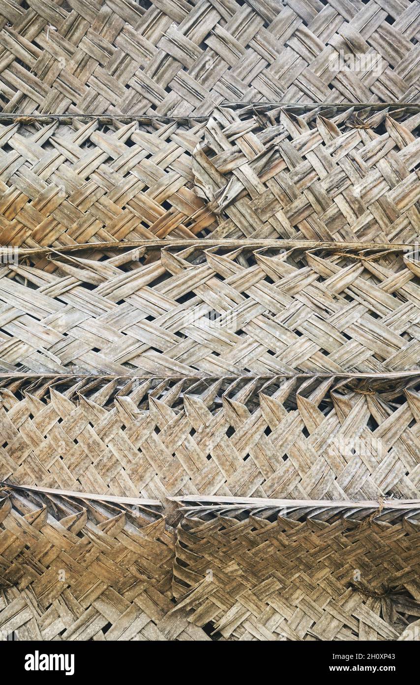 Dried palm leaf braid wall, natural background. Stock Photo