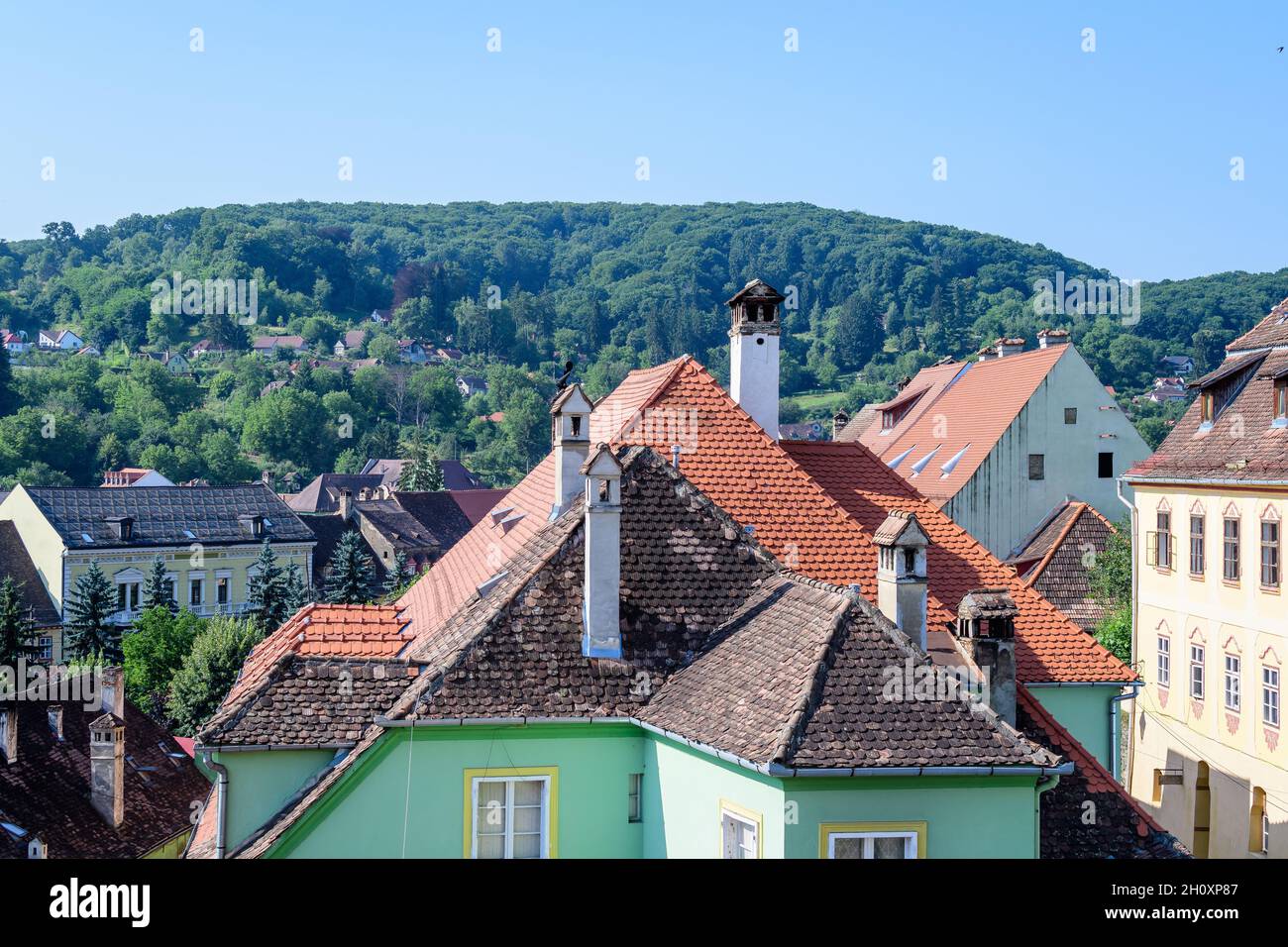 Landscape with view over houses of Sighisoara city, in Transylvania (Transilvania) region of Romania, in a sunny summer day Stock Photo