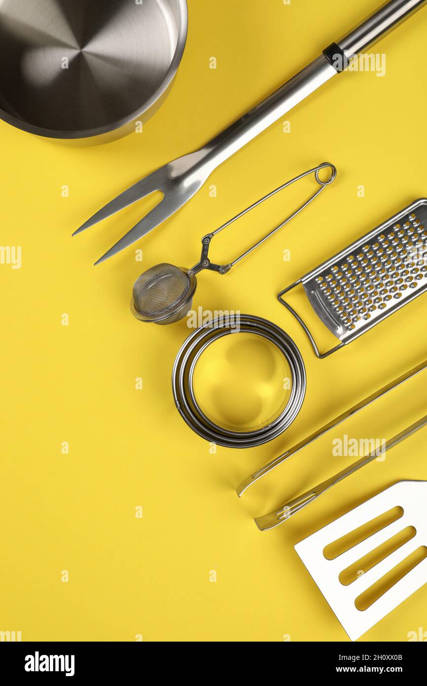Kitchen utensil on yellow background, space for text Stock Photo Alamy