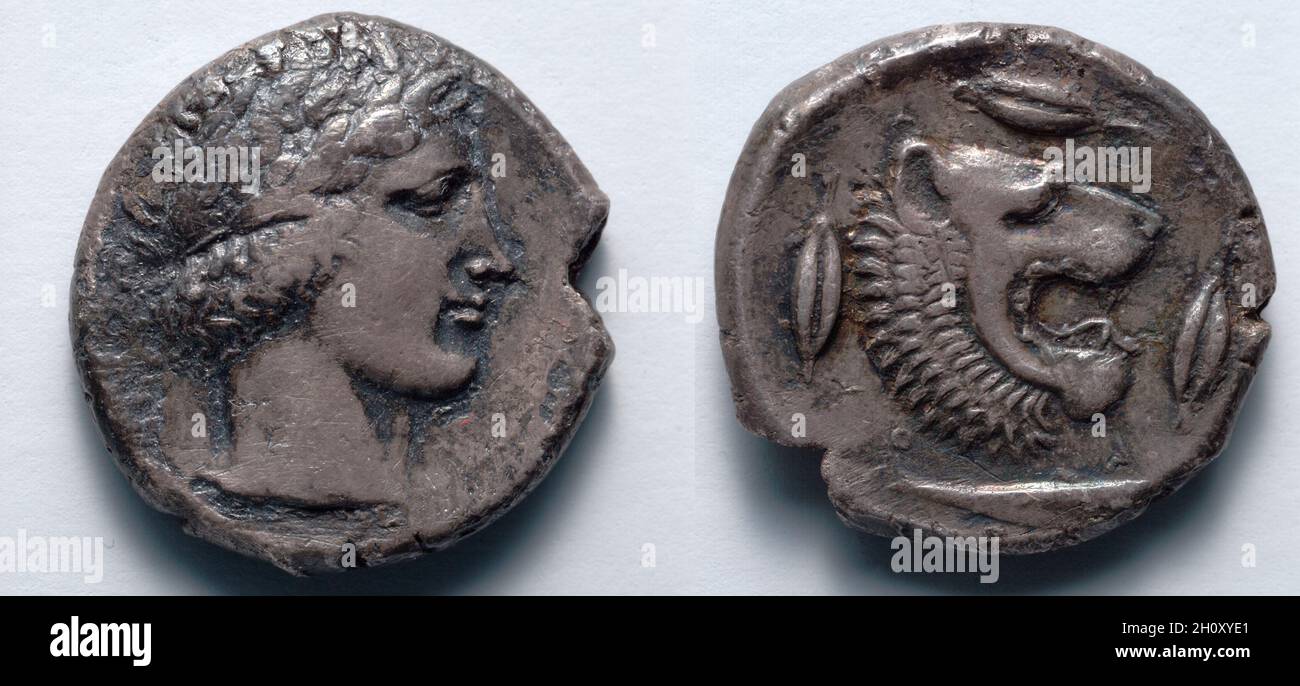 Tetradrachm: Apollo (Obverse); Lion (Reverse), 466-422 BC. Greece, Leontini (Sicily). Silver; diameter: 2.5 cm (1 in.).  The lion, king of the beasts and an animal associated with regal and heroic power, featured prominently on the coinage of many ancient Greek city-states. Artists placed the lion in a variety of poses, sometimes including the whole body, at other times the foreparts or just the head. Although it may once have roamed nearby, for many Greeks the lion was a monster nearly as exotic as the Chimaera, of which it formed a part, together with a goat head and snake-headed tail. Stock Photo
