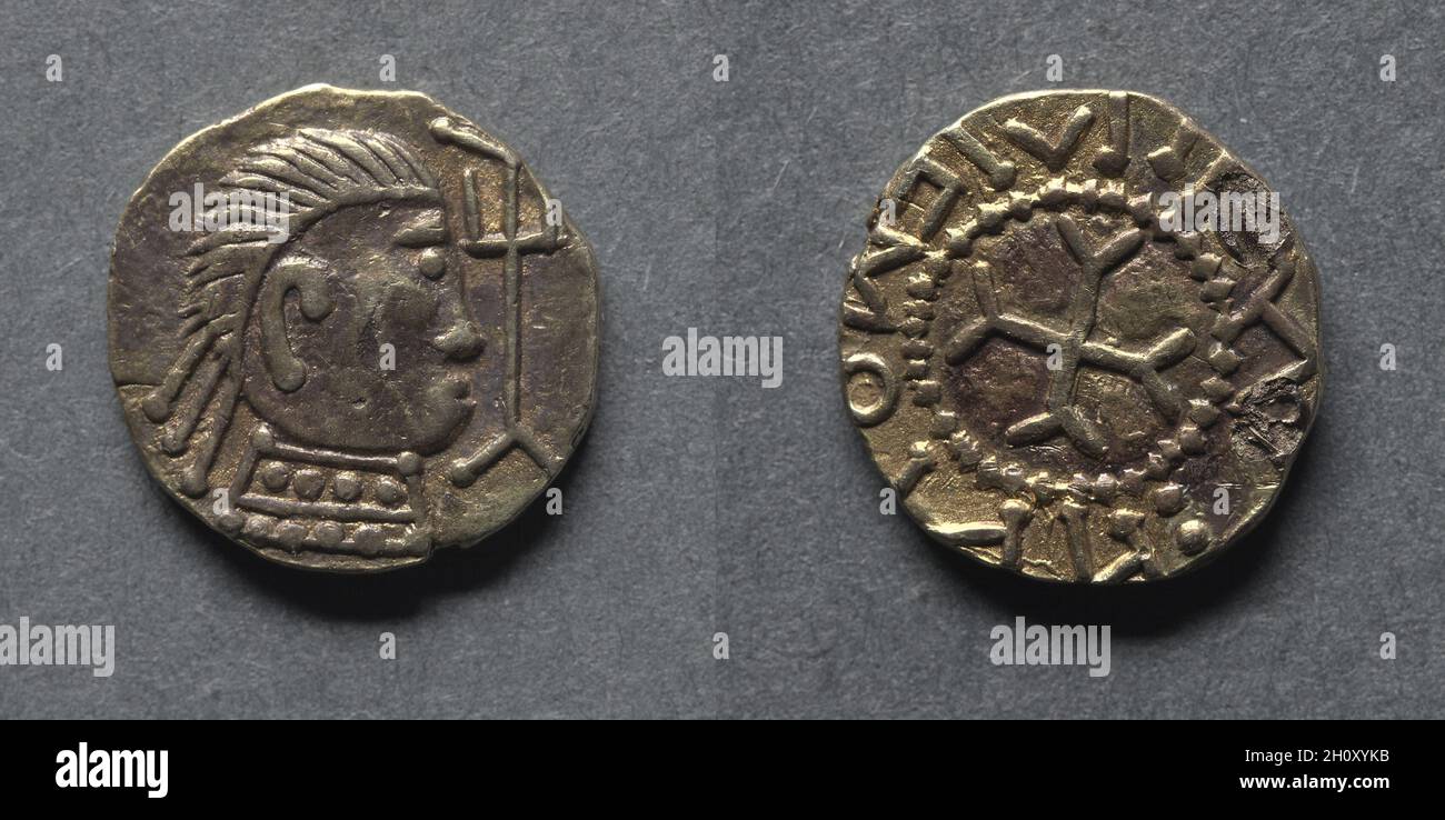 Witmen Tremissis: Bust and Trident (obverse); Cross Fourchée (reverse), early 600s. England, Anglo-Saxon, early 7th century. Gold; diameter: 1.1 cm (7/16 in.).  The Crondall Hoard is a hoard of coins that was found in 1828 in the village of Crondall in the English county of Hampshire. It is believed to date to the seventh century and was studied by Dr. Carol Humphrey Vivian Sutherland (1908-1986), an English numismatist. He characterized this coin as being a close copy of the Witmen prototype, the most common type found in the hoard. Witmen, or his design, featuring a bust on one side and a cr Stock Photo