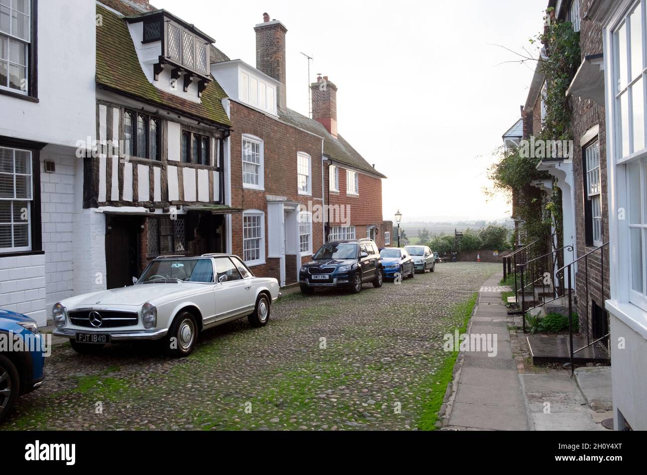 Mercedes-Benz 230 sports car parked outside half-timbered house on cobblestone Watchbell street Rye East Sussex England Great Britain UK KATHY DEWITT Stock Photo