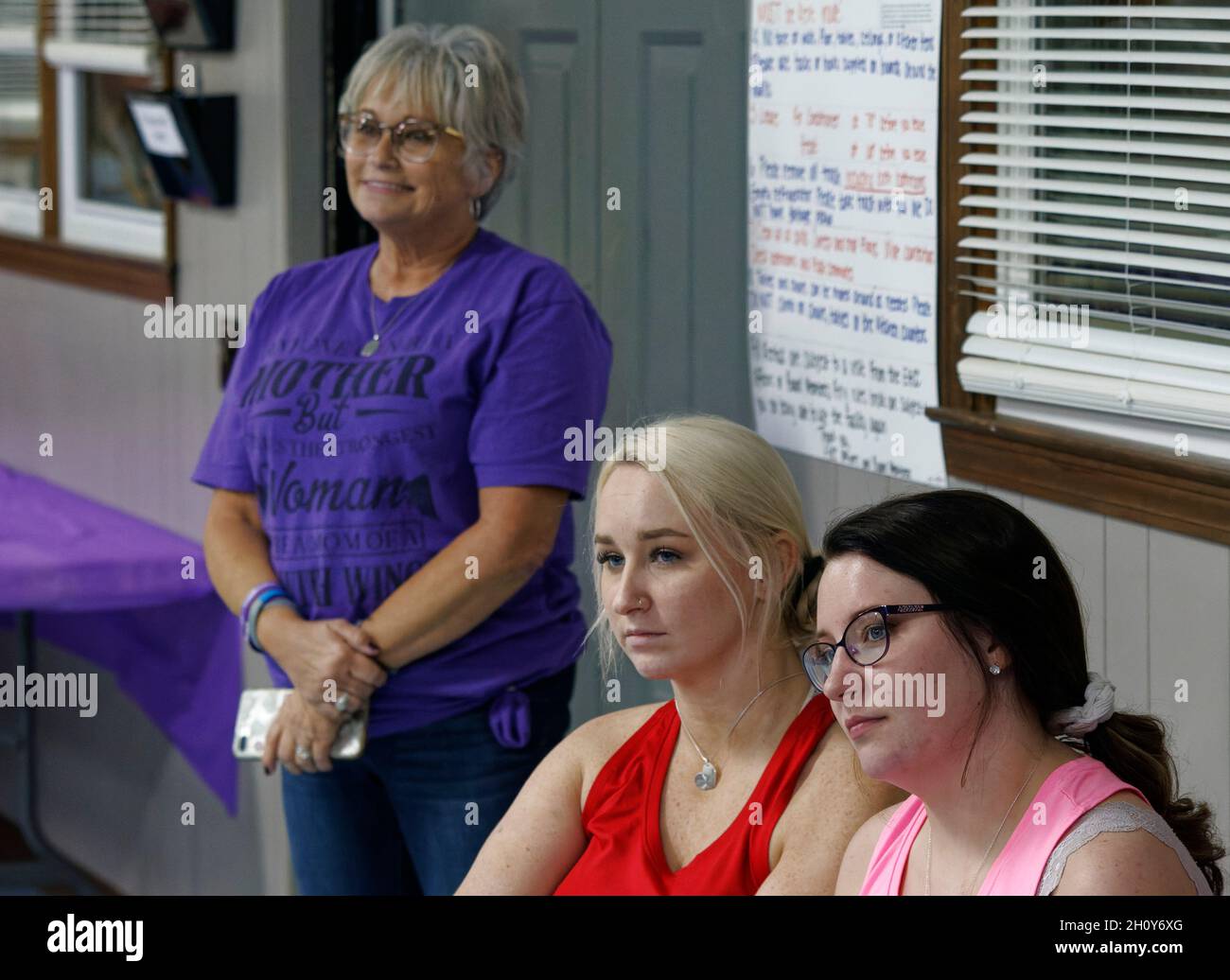 Macey Armstrong (from right), Mollie Chandler and Stephanie Beard listen to a speaker during 'Our Community Fight: Remembering Our Loved Ones & Honoring Their Legacy,' a public forum hosted by the nonprofit Booker D. Foundation on Friday, Oct. 1, 2021 at the East Hickman Community Center in Lyles, Hickman County, TN, USA. The foundation was founded by the family of Booker Dalton Beard, a Hickman County man who died from a drug overdose exactly one year earlier and two days after his 25th birthday. (Apex MediaWire Photo by Billy Suratt) Stock Photo