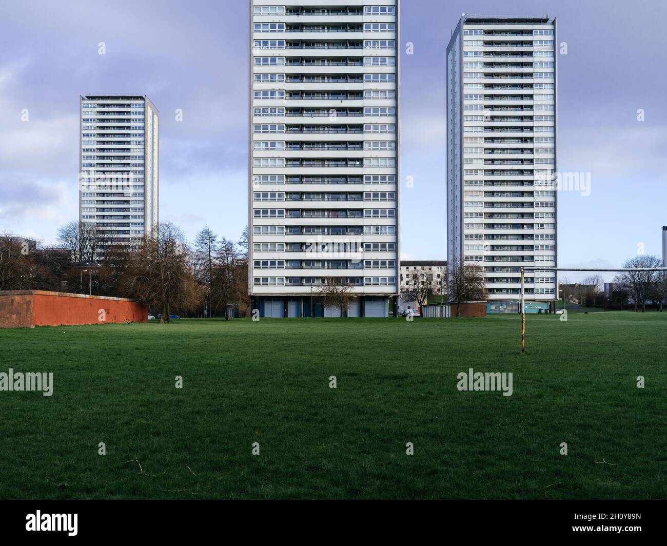 Football pitch and goalpost in the foreground of the Wyndford Road high flats in Maryhill, Glasgow, Scotland. Stock Photo