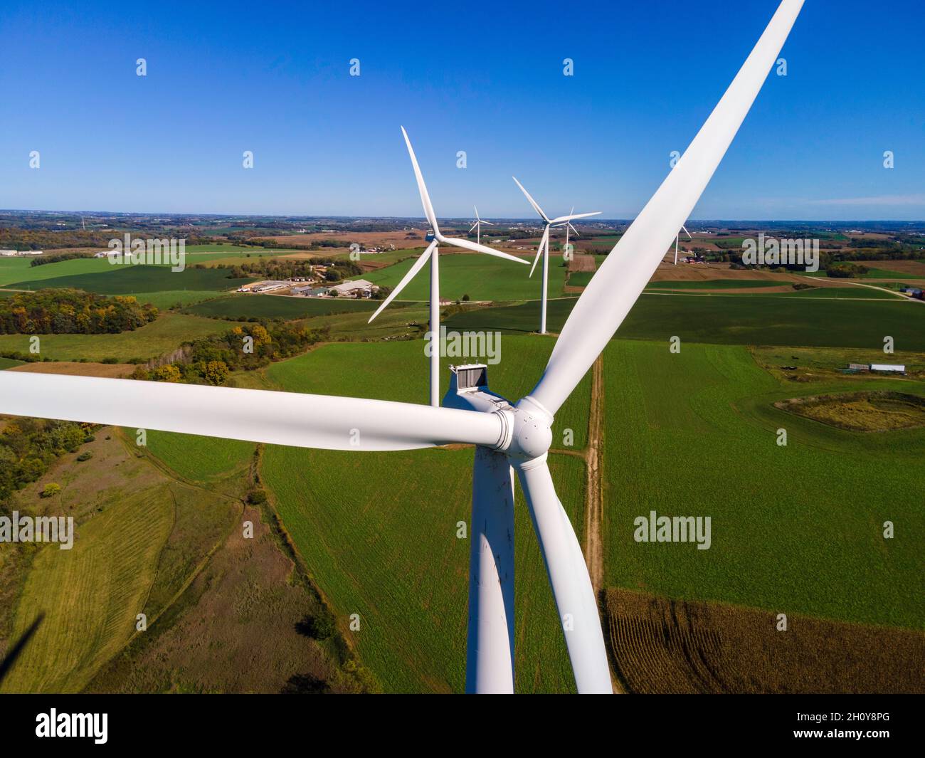 A wind turbine (windmill) generates electricity on a windy day in