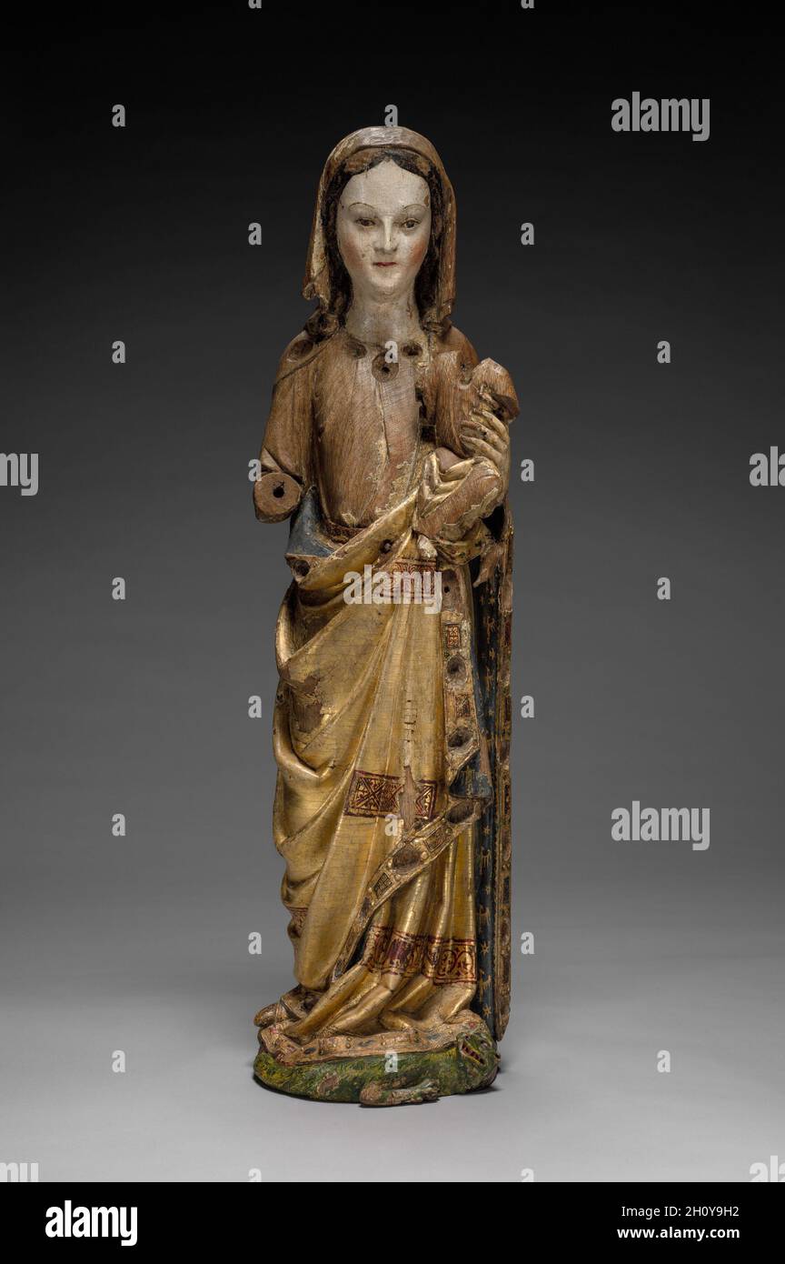 Virgin and Child, late 1200s. Mosan (Valley of the Meuse), Liège(?), late 13th century. Wood (oak) with polychromy and gilding; overall: 83 x 24 x 20 cm (32 11/16 x 9 7/16 x 7 7/8 in.).  This sculpture is a rare survival in wood from the valley of the Meuse River (modern Belgium and Holland), an important region for the production of ecclesiastical art in the 1100s and 1200s. The elegantly draped figure is remarkable for the preservation of much of its original paint and gilding, including the Virgin's gilded mantle highlighted with decorative bands of geometric patterns and the green dragon o Stock Photo