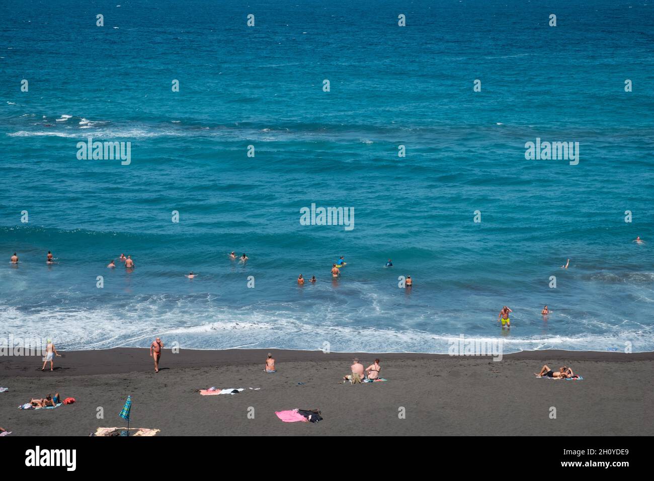 Tenerife, Spain - September, 2021: People at beach swimming in ocean in Puerto de la Cruz, Tenerife, Canary Islands Stock Photo