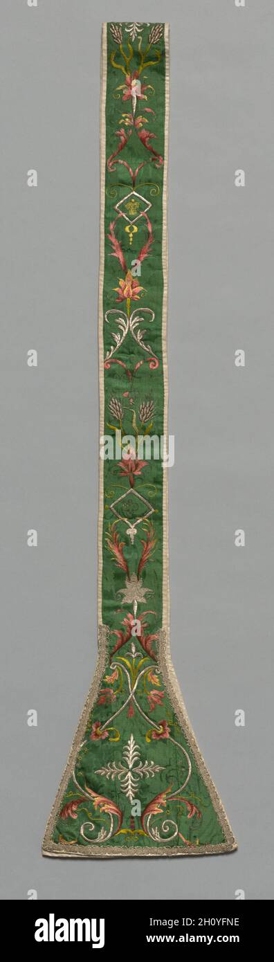 Embroidered Stola, 1700s. Italy, 18th century. Silk and silver thread on silk damask ground; embroidery; overall: 213.3 x 24.8 cm (84 x 9 3/4 in.).  Sheaves of wheat and bunches of grapes, symbols of bread and wine in the Mass, are embroidered with silver-metal thread amid scrolling leaves on the green silk-damask ground. Liturgical colors—white, red, green, and black, purple, or blue—mandated by Pope Innocent III in the late 1100s were widely ignored by the 1700s, replaced primarily by a lavish use of gold, silver, and pastel silk thread embroidered on white silk fabrics. Long matching stoles Stock Photo