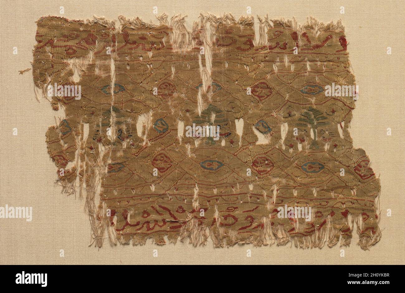 Fragment of a Tiraz, 1130 - 1149. Egypt, Fatimid period, probably during Caliphate of al-Hafiz, AH 524-544 (A.D. 1130-1149). Tapestry (originally inwoven in a tabby ground); linen and silk; overall: 11.5 x 17.2 cm (4 1/2 x 6 3/4 in.). Stock Photo