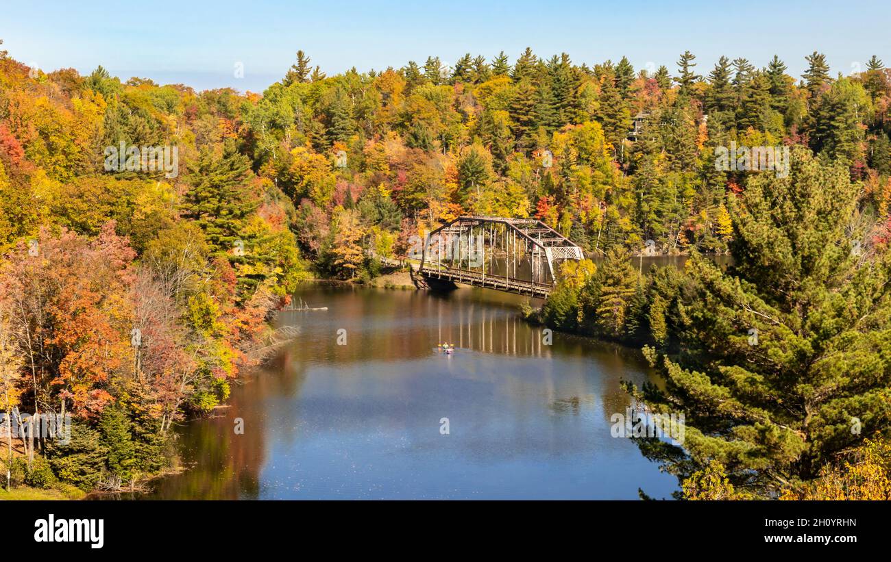 Kayakers paddle under the CR510 Dead River Bridge, near Marquette
