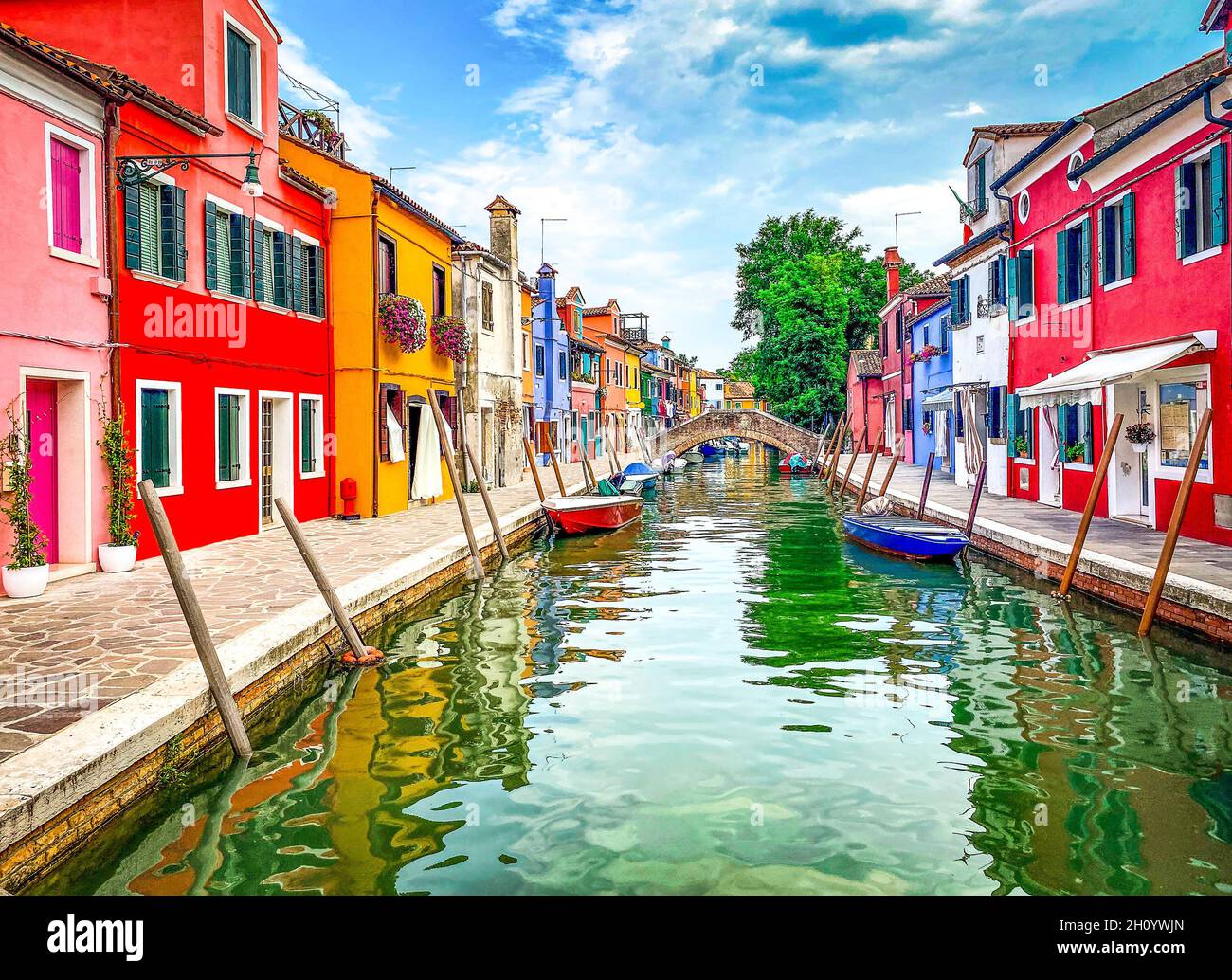 Boats and colorful traditional painted houses in a canal street houses ...