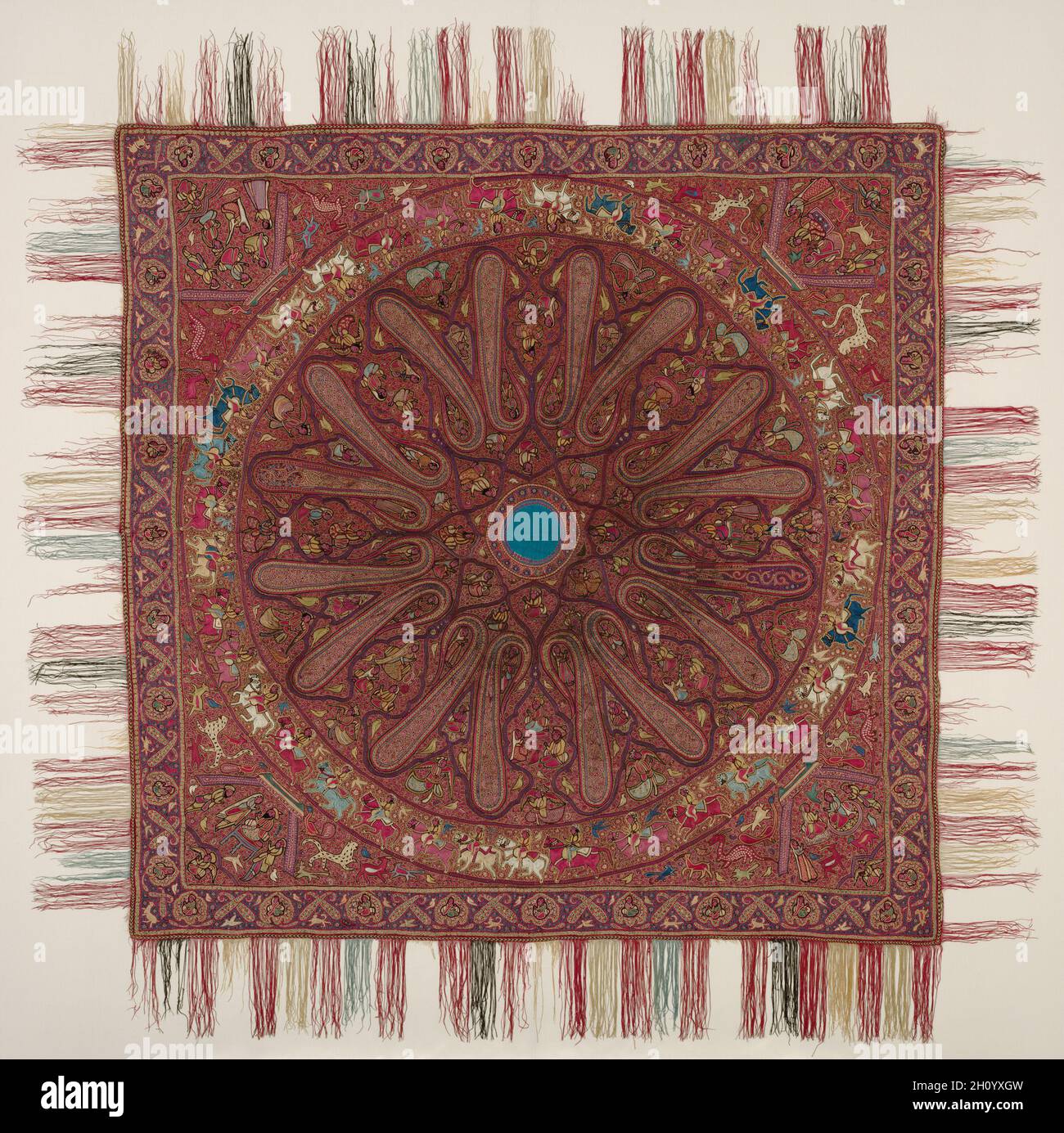 Square Shawl, c. 1850-70. India, Kashmir. Silk and silver filé, wool: chain stitch embroidery; overall including fringe: 212.1 x 212.1 cm (83 1/2 x 83 1/2 in.).  By the 1800s, the Himalayan foothill region of Kashmir was renowned for distinctive embroideries, and Kashmiri shawls were coveted by women throughout the British Empire. The center of this square shawl is in the form of an eight-petaled lotus, a symbol for the sun, and around it are the elongated forms of slender cypress trees, which became the inspiration for paisley. Every space is populated with figures: seated, standing, male, fe Stock Photo